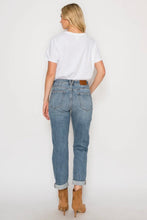 Load image into Gallery viewer, Woman wearing light blue jeans and a white t-shirt on a plain background