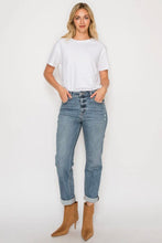 Load image into Gallery viewer, Woman wearing a white t-shirt and blue jeans on a white background