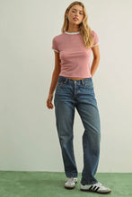 Load image into Gallery viewer, Woman wearing a pink t-shirt and blue jeans standing against a plain background