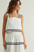 Load image into Gallery viewer, Woman wearing a white top and skirt with black trim on a plain background