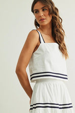 Load image into Gallery viewer, Woman wearing a white top with black trim on a plain background