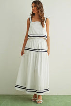 Load image into Gallery viewer, Woman wearing a white outfit with black stripes on a plain background