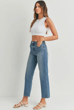 Load image into Gallery viewer, Woman wearing a white sleeveless top and blue jeans on a plain background
