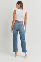 Load image into Gallery viewer, Woman wearing blue jeans and a white top on a plain background