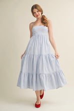 Load image into Gallery viewer, Woman wearing a blue and white striped dress on a beige background