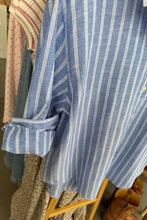 Load image into Gallery viewer, Folded blue and white striped shirt on a wooden surface