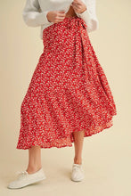 Load image into Gallery viewer, Person wearing a red floral skirt on a beige background