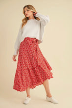 Load image into Gallery viewer, Woman wearing a white sweater and red floral skirt on a beige background