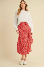 Load image into Gallery viewer, Woman wearing a white sweater and red floral skirt on a beige background