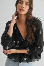 Load image into Gallery viewer, Woman wearing a black blouse with floral embroidery on a white background