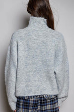 Load image into Gallery viewer, A person shown from the back wearing a light heather gray fuzzy turtleneck sweater and blue plaid pants against a plain light gray background.