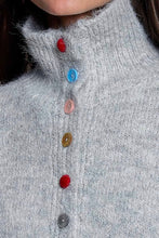 Load image into Gallery viewer, Close-up of a fuzzy light gray turtleneck sweater with colorful buttons in red, blue, pink, yellow, and gray, worn by a model.