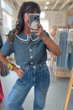 Load image into Gallery viewer, Woman taking a mirror selfie wearing a denim outfit in a store.