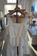 Load image into Gallery viewer, White lace dress on a hanger in a store setting