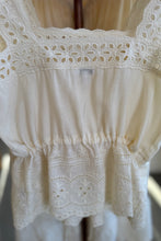 Load image into Gallery viewer, White lace top on a hanger with a blurred background