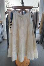 Load image into Gallery viewer, White lace dress on a hanger in a clothing store