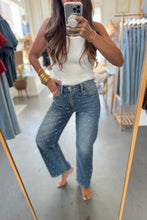 Load image into Gallery viewer, Person taking a mirror selfie wearing a white tank top and blue jeans in a clothing store.
