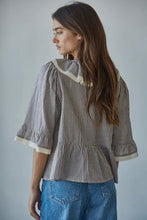 Load image into Gallery viewer, Woman wearing a striped shirt and jeans against a plain background