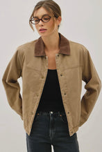 Load image into Gallery viewer, Woman wearing a beige jacket over a black top and jeans on a plain background