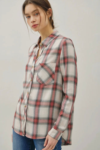 Woman wearing a plaid shirt with a plain background