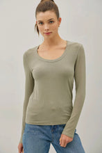 Load image into Gallery viewer, Woman wearing a green long-sleeve top and blue jeans against a plain background