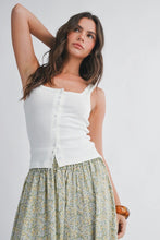 Load image into Gallery viewer, Woman wearing a white sleeveless top and floral skirt on a plain background