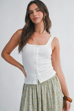 Load image into Gallery viewer, Woman wearing a white sleeveless top and patterned skirt on a plain background