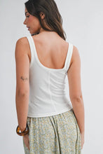 Load image into Gallery viewer, Woman wearing a white tank top and floral pants on a plain background