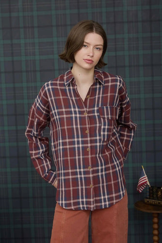 Woman wearing a plaid shirt against a plaid wall