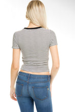 Load image into Gallery viewer, A woman viewed from the back wearing a fitted short-sleeve striped top with thin black and white horizontal lines and blue jeans, against a plain white studio background.