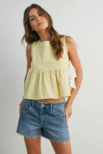Load image into Gallery viewer, Woman wearing a yellow sleeveless top and denim shorts on a plain background