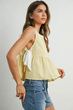 Load image into Gallery viewer, Woman wearing a yellow sleeveless top with a bow and denim shorts on a plain background