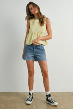 Load image into Gallery viewer, Woman wearing a yellow sleeveless top and denim shorts on a plain background