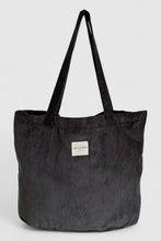 Load image into Gallery viewer, Black corduroy tote bag with a visible brand label on a light gray background