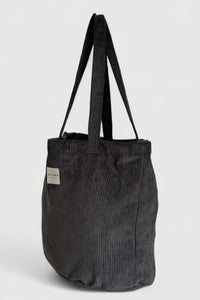 Black corduroy tote bag on a light gray background