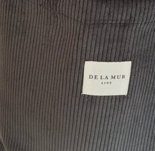 Load image into Gallery viewer, Close-up of dark gray corduroy fabric with a &#39;De La Mur&#39; label.