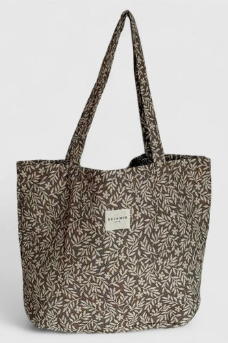 Tote bag with leaf pattern on a light gray background