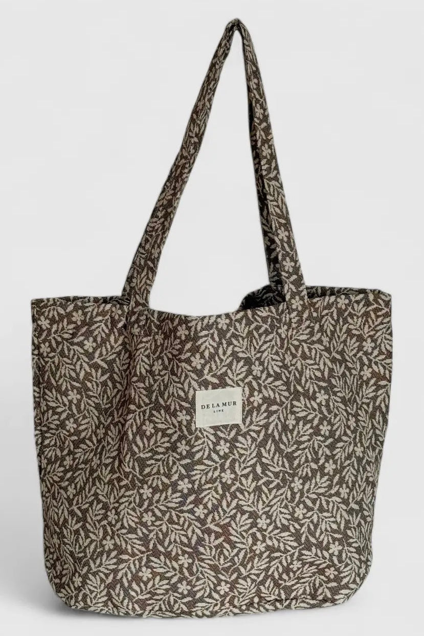 Tote bag with leaf pattern on a light gray background