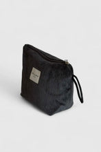 Load image into Gallery viewer, Black textured pouch with a visible brand label on a light gray background