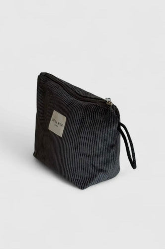 Black textured pouch with a visible brand label on a light gray background