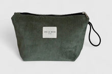 Load image into Gallery viewer, Green ribbed clutch bag with a visible brand label on a light gray background