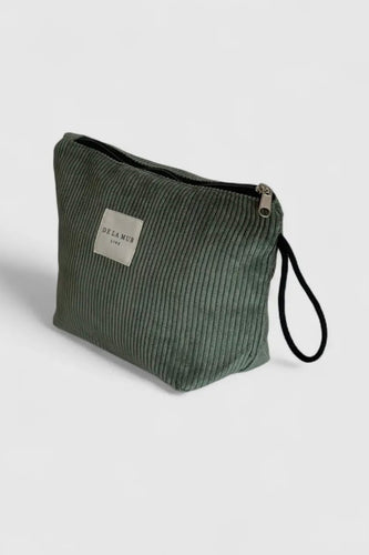 Green textured pouch with a strap on a light gray background