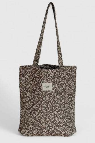 Tote bag with leaf pattern on a light gray background