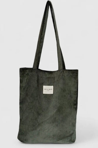 Green corduroy tote bag with a visible brand label on a white background