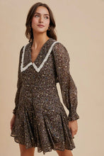 Load image into Gallery viewer, Woman wearing a floral dress with lace trim on a beige background