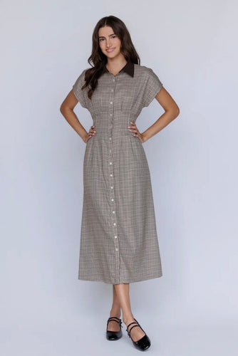 Woman wearing a checkered dress on a white background