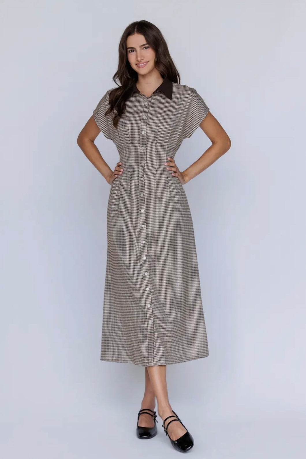 Woman wearing a checkered dress on a white background