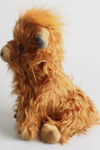 Plush toy resembling a lion on a white background