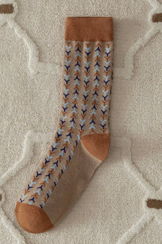 Patterned sock with brown accents on a textured surface