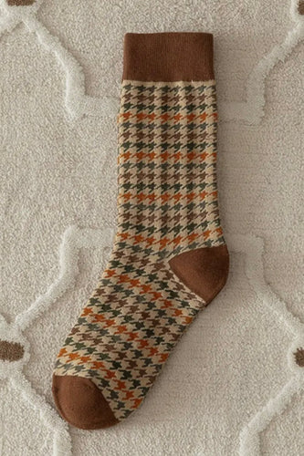 Patterned sock with brown accents on a textured surface